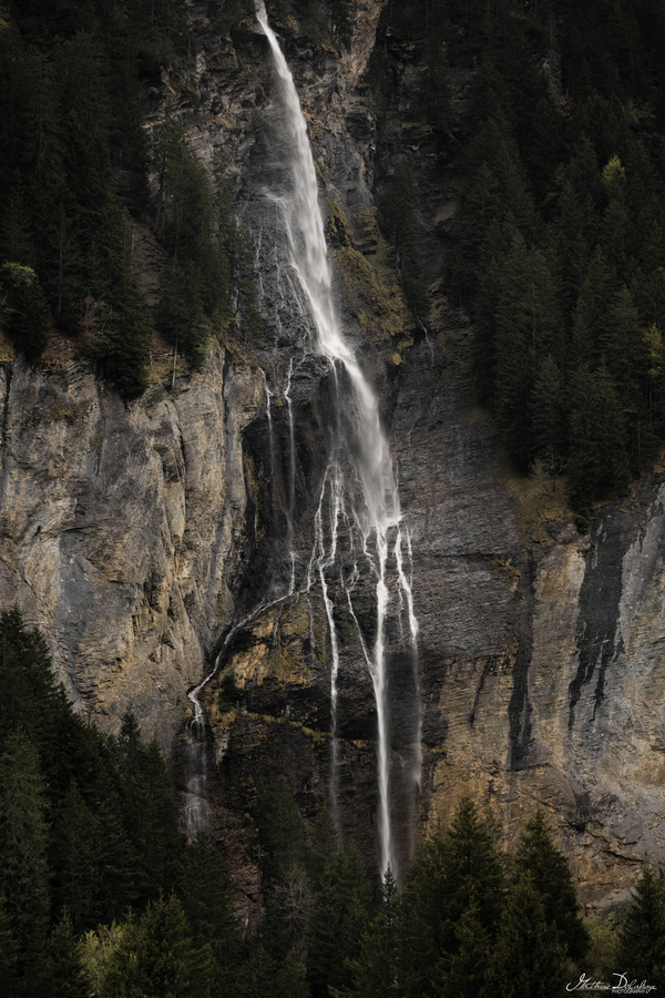 Vertical Photograph of a Waterfall in Rosenlaui Valley